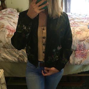 Black nylon windbreaker jacket with flower accents